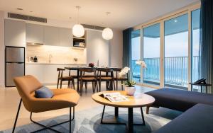 a living room with a kitchen and a dining room at Alma Resort Cam Ranh in Cam Ranh