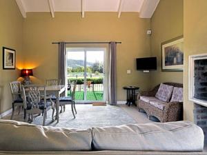 a living room with a table and a couch at Auberge La Dauphine Guest House in Franschhoek