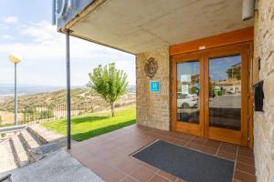 a door to a building with a view of a hill at Hotel Alda Triskel in Sos del Rey Católico