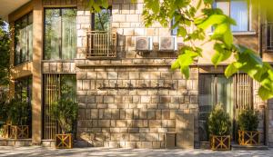 a stone building with potted plants in front of it at THE HIDDEN BANK: Silver Bullet in Plovdiv