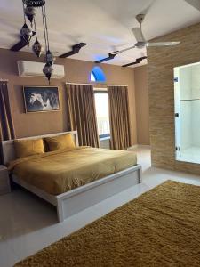 a bedroom with a large bed with a rug at Valley Guest Home in Nizwa