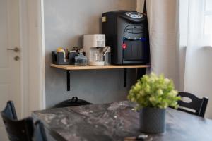 a table with a coffee maker on a shelf at צימר אדל - Zimmer Adel in Yavneʼel