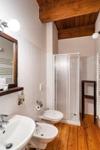 a bathroom with two sinks and a shower at Dimora Storica Casa Vanni in Villadossola