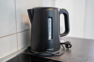 a black kettle sitting on top of a counter at Perfect stay 2 in Maribor