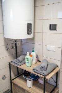 a bathroom with a shelf with towels and a light at Perfect stay 2 in Maribor