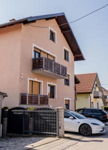 a white car parked in front of a house at Perfect stay 2 in Maribor