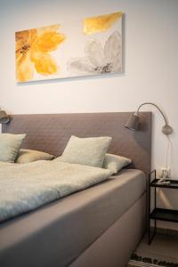 a bedroom with a bed with two paintings on the wall at Perfect stay 2 in Maribor