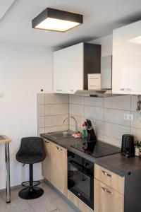 a kitchen with a sink and a chair in it at Perfect stay 2 in Maribor
