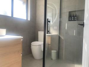 a bathroom with a toilet and a glass shower at Beautiful Mountain Views in Kings Meadows