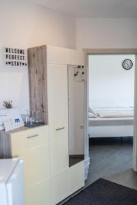 a white dresser in a room with a bed at Perfect stay in Šentilj