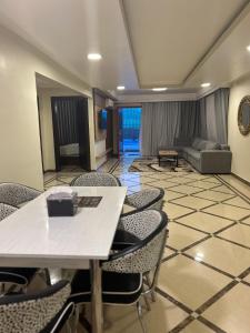 una camera con sedie, tavolo e divano di منتجع درة الشرق للعائلات a Dammam