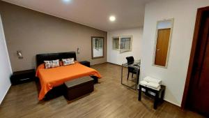 a bedroom with a bed and a desk in it at Il Mirto E La Rosa in Arenella