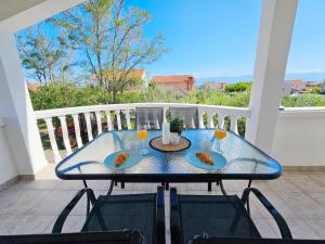 a table with two plates of food and drinks on a balcony at Apartment Loli - Nin in Nin
