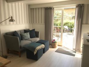 a living room with a couch and a sliding glass door at Staevnegaarden in Flødstrup