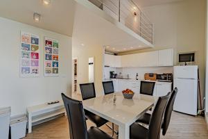a kitchen and dining room with a white table and chairs at Vila Inga - Postira in Postira
