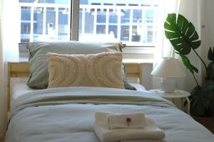 a bed with two white towels on top of it at Stijlvol App in Genk Centrum in Genk