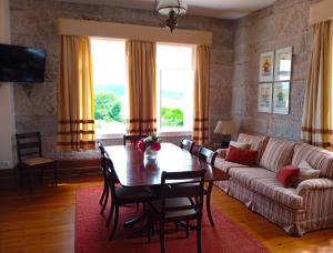 a living room with a table and a couch at Casa Pita Caminha in Caminha