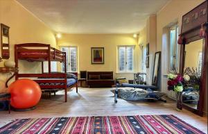 a room with two bunk beds and a rug at A Casa di Maica in Gualdo