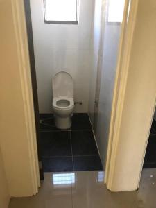 a small bathroom with a toilet in a stall at Bula Stay in Nadi