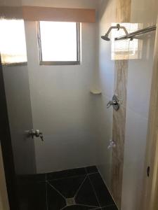 a bathroom with a shower with a window at Bula Stay in Nadi