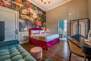 a hotel room with a bed and a couch at Maison Medina in Mdina