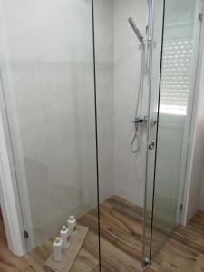 a shower stall in a bathroom with four toilets at Casa Raios de Sol in Burgau