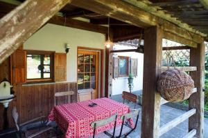 a dining room with a red table and chairs at River House Mojstrana in Mojstrana