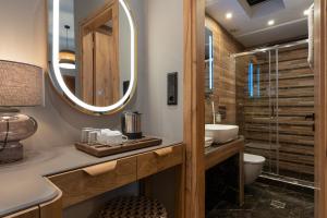 a bathroom with a sink and a mirror at Semiramis Guesthouse in Adamantas