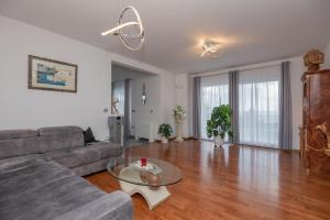 a living room with a couch and a table at Villa Mira Mel mit privaten Pool - Makarska Exklusiv in Makarska