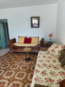 a living room with a couch and a table at Maison de campagne piscine et jardin privatifs près de la plage in Aléria +10 photos
