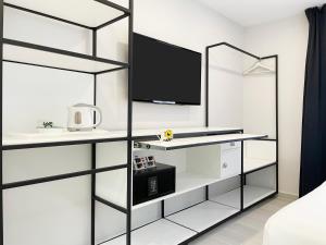a bedroom with white walls and a black and white shelves at Four Rooms in Muxia +24 photos