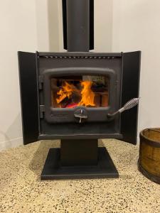 a stove that is sitting on a counter at Penneshaw Ocean View Premium Couples Retreat "The Rusty Kangaroo" in Penneshaw