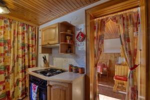 a kitchen with a stove and a sink in a room at Forest Retreat Bonidesa - Terrace & Jacuzzi - Happy Rentals in Ljubno +32 photos