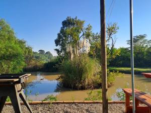 a view of a river from a porch at A Night at the Museum Vintage Glamping in Roodepoort