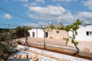 an external view of a house with turrets at Trulli Miriam: Enchanting Apulian Getaway in Martina Franca +24 photos
