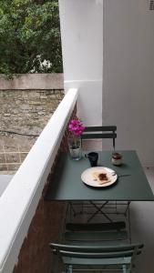 a table with a plate of food on a balcony at Studio climatisé intra muros balcon in Avignon