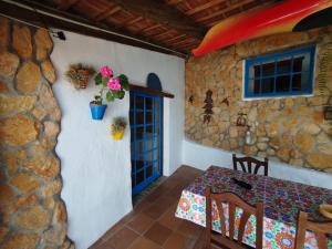 a dining room with a table and a stone wall at La cuadra de Juan in Icod de los Vinos