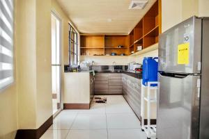 a small kitchen with a refrigerator at Campo Filipino Dormitelle powered by Cocotel in Baguio +3 photos