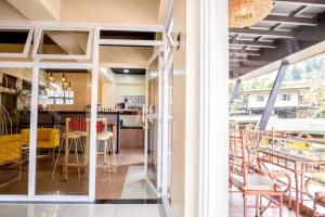 a kitchen and dining room with a table and chairs at Campo Filipino Dormitelle powered by Cocotel in Baguio