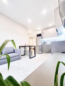a living room with a couch and a kitchen at Most City Area Lux Studio in Dnipro