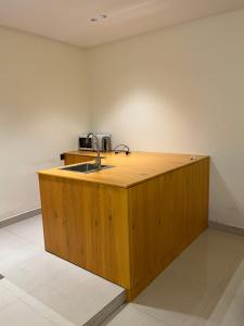 a kitchen with a wooden counter with a sink at شاليهات حائط حجري in Riyadh