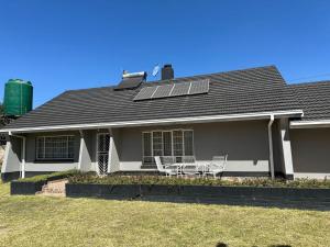 a house with a solar panel on the roof at Impeccable 3-Bed House in Harare in Harare