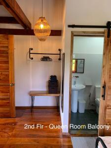 a bathroom with a table and a sink and a light at Wayans Siargao in General Luna