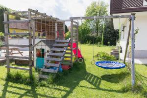 a playground with a ladder and a swing at Familytime am Traunsee in Altmünster