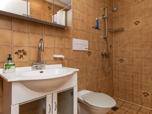 a bathroom with a sink and a toilet and a shower at 5 person holiday home in R m in Sønderby