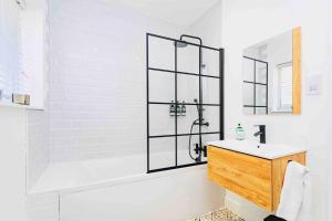 a white bathroom with a shower and a sink at Luxury Ocean Playroom SEA SALT CHALET in Barton on Sea +32 photos
