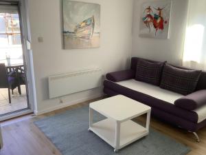 a living room with a couch and a table at Apartment 877-2 in Bibinje