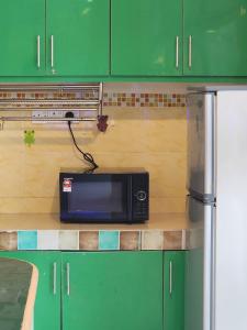 a microwave sitting on a counter in a kitchen at BEAR HOTEL at NILAI in Nilai
