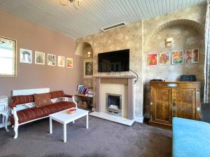 uma sala de estar com um sofá e uma lareira em Sheffield's 3BR Retreat em Hillsborough