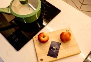 two apples on a cutting board next to a blender at Kin Wander Tan Quy in Ho Chi Minh City